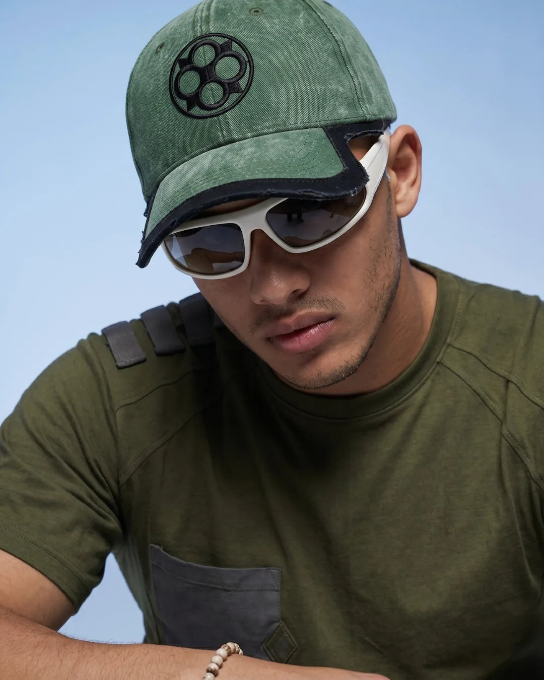 Olive Washed Badge Cap – FOUROZ unisex green cap – on model